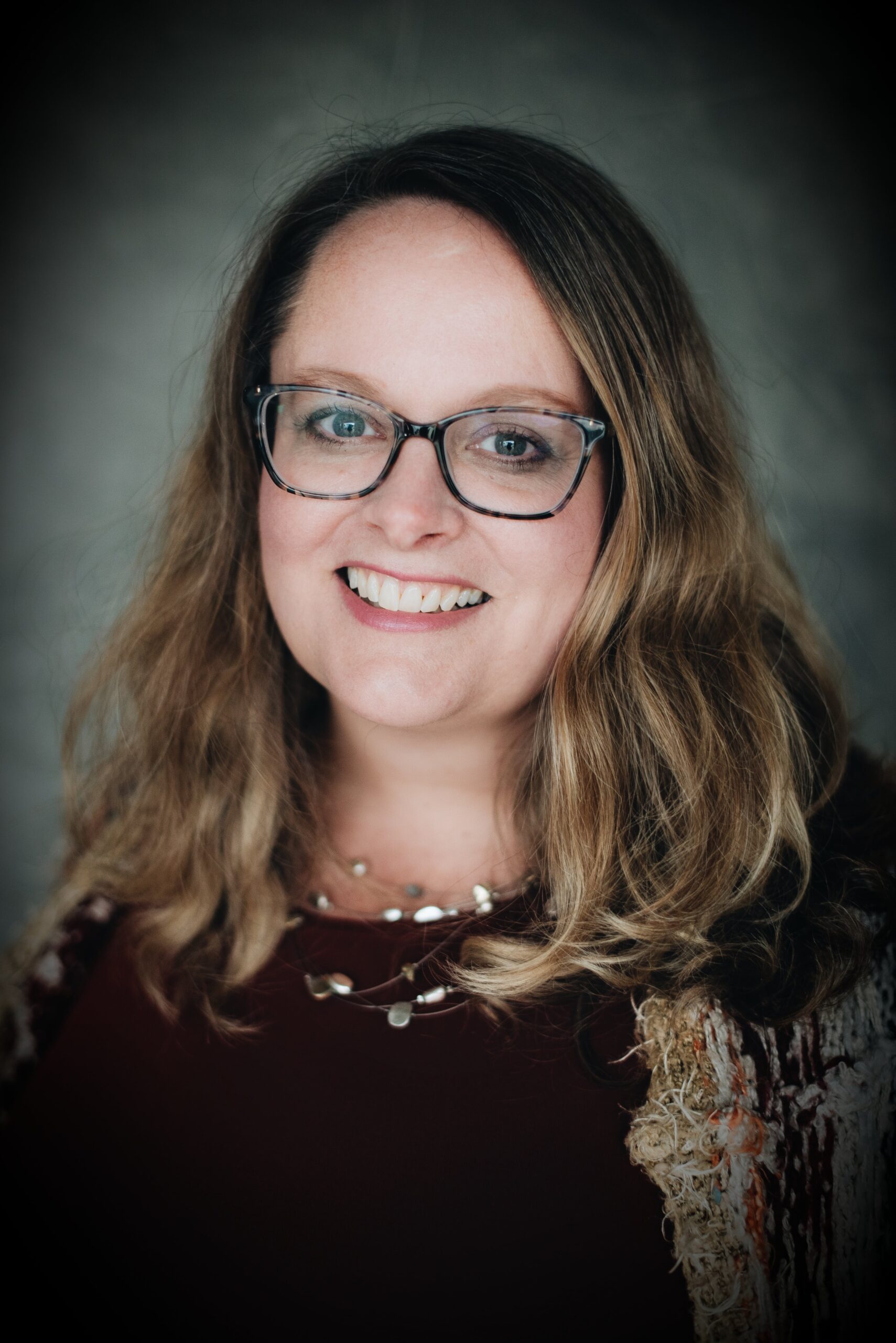 Jennifer Nordhagen, a white woman with curly dark blonde hair and a warm smile