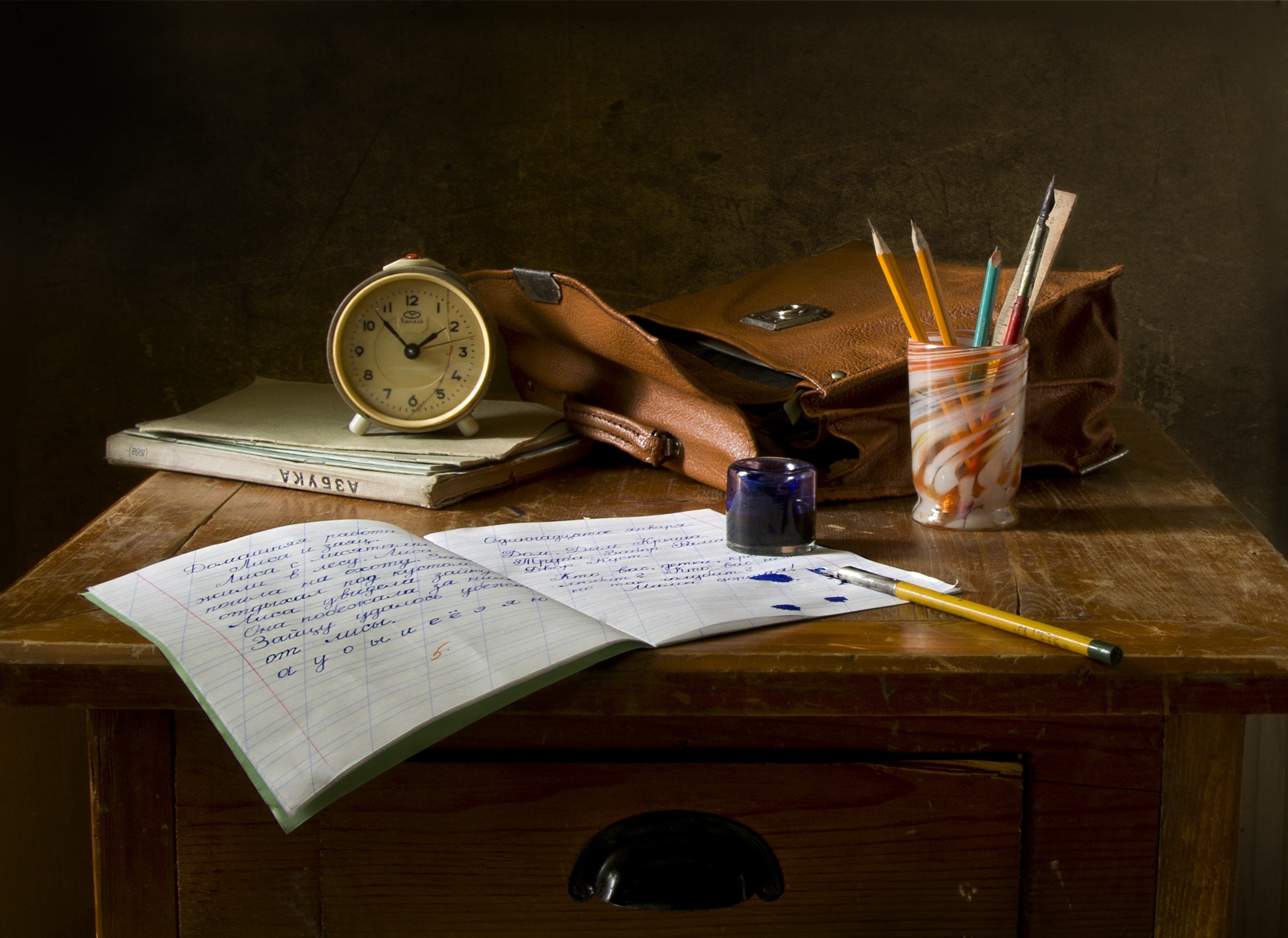 A vintage looking desk with written supplies on it